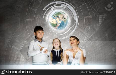 Geography lesson. Young teacher and her pupils examining Earth planet. Elements of this image are furnished by NASA