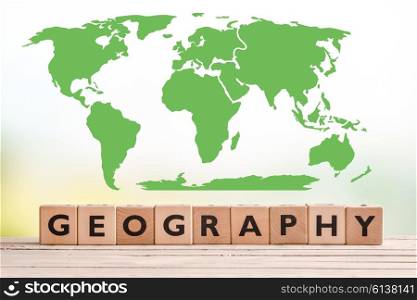 Geography sign with a world map on a wooden desk