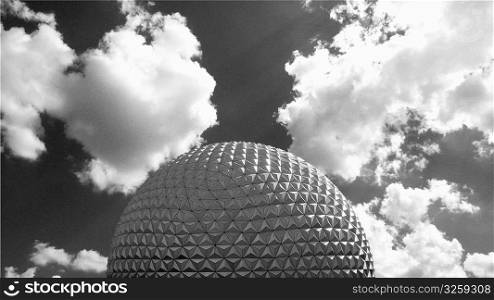Geometric dome against clouded sky.