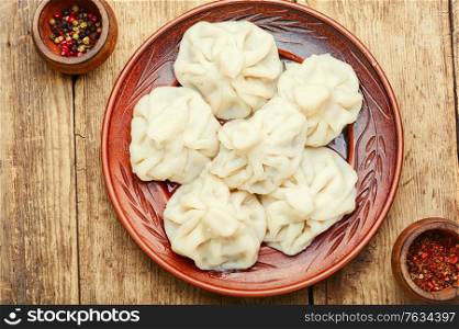 Georgian dumplings khinkali with meat on wooden table. Khinkali with meat