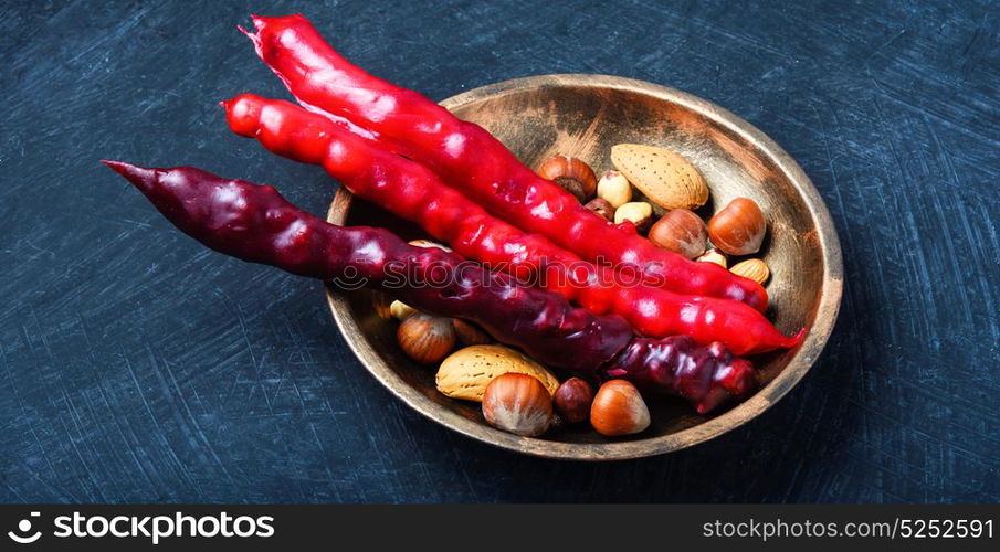 Georgian national delicacy. Turkish churchkhela with almonds and hazelnuts on slate table