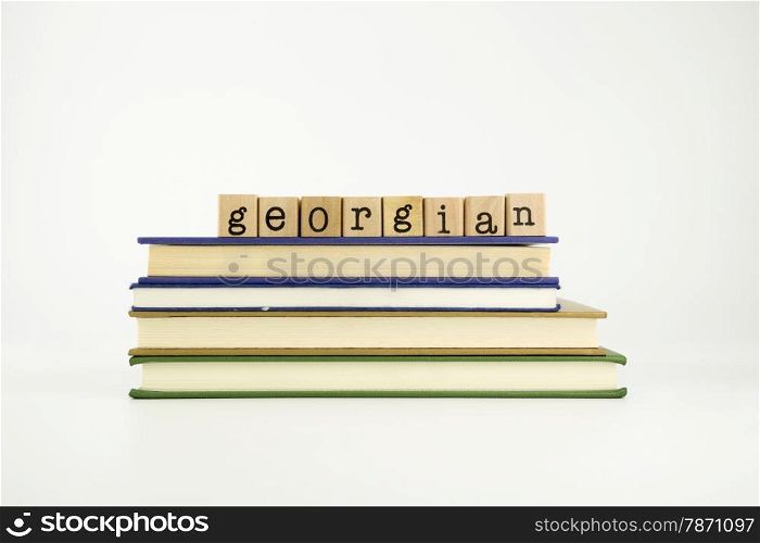 georgian word on wood stamps stack on books, language and conversation concept