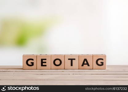 Geotag sign on an outdoor wooden table