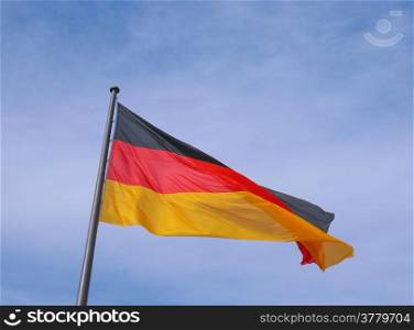 German flag. The national German flag of Germany over blue sky