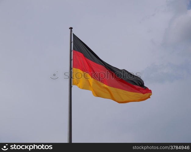 German flag. The national German flag of Germany over blue sky