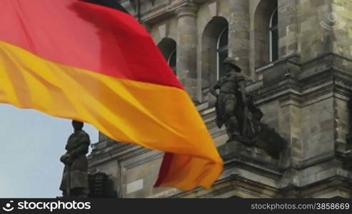 German flag waving in front of Parliament building in Berlin Roof of the building in Berlin, close up