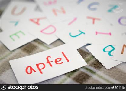 German; Learning the New Word with the Alphabet Cards (Translation; Apple)