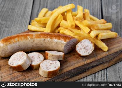 German sausage and potato fry on a wooden. German sausage and potato fry
