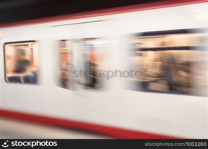 German subway train in motion, defocused image. Public transport blur background. High-speed subway train. Traffic concept in a subway station.