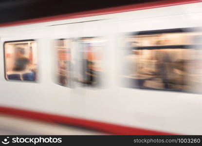 German subway train in motion, defocused image. Public transport blur background. High-speed subway train. Traffic concept in a subway station.