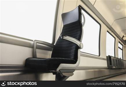German train interior with a black chair and bright windows. Train wagon with a single seat and white interior. Eco-friendly and cozy public transport