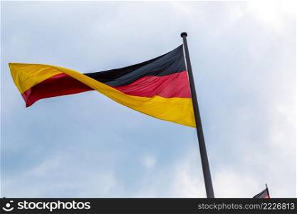 Germany flag in front of blue sky in summer day
