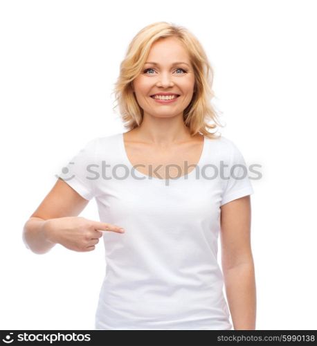 gesture, advertisement and people concept - smiling woman in blank white t-shirt pointing finger to herself