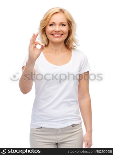 gesture, advertisement and people concept - smiling woman in blank white t-shirt showing ok hand sign