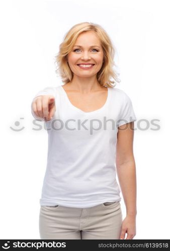 gesture, advertisement and people concept - smiling woman in blank white t-shirt pointing finger to you