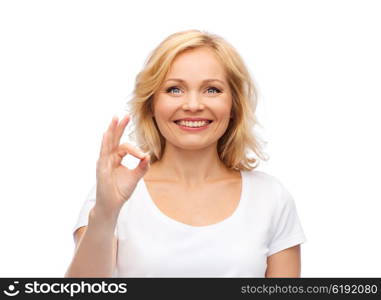 gesture, advertisement and people concept - smiling woman in blank white t-shirt showing ok hand sign