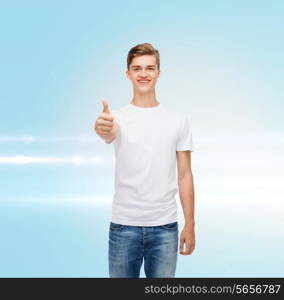 gesture, advertising and people concept - smiling young man in blank white t-shirt showing thumbs up over blue laser background