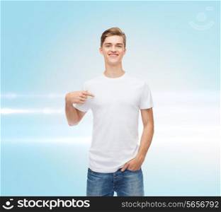 gesture, advertising and people concept - smiling young man in blank white t-shirt pointing finger on himself over blue laser background