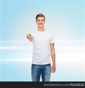 gesture, advertising and people concept - smiling young man in blank white t-shirt pointing at you over blue laser background