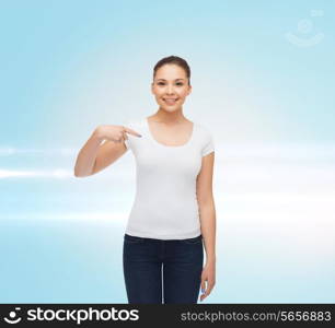 gesture, advertising and people concept - smiling young woman in blank white t-shirt pointing finger on herself over blue laser background