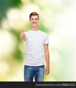 gesture, advertising, ecology and people concept - smiling young man in blank white t-shirt showing thumbs up over green background