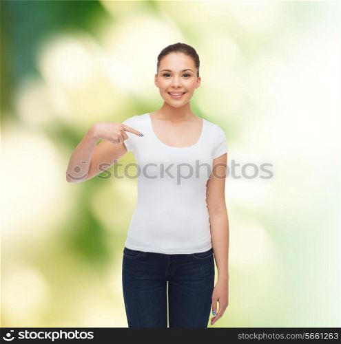 gesture, advertising, ecology and people concept - smiling young woman in blank white t-shirt pointing finger on herself over green background