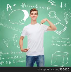 gesture, advertising, education, school and people concept - smiling young man in blank white t-shirt pointing finger on himself over green board background with doodles