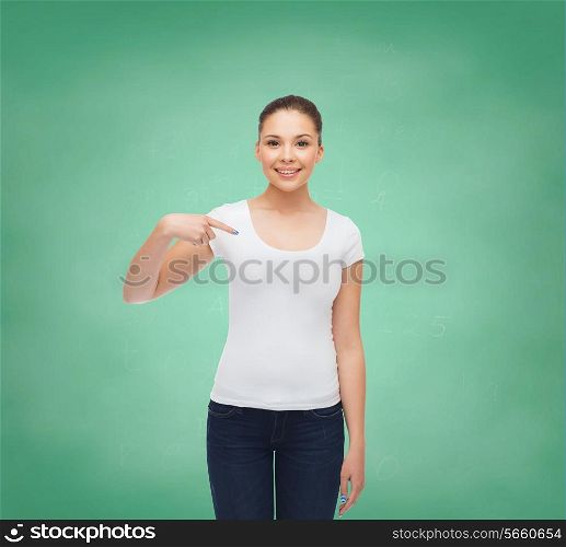 gesture, advertising, education, school and people concept - smiling young woman in blank white t-shirt pointing finger on herself over green board background