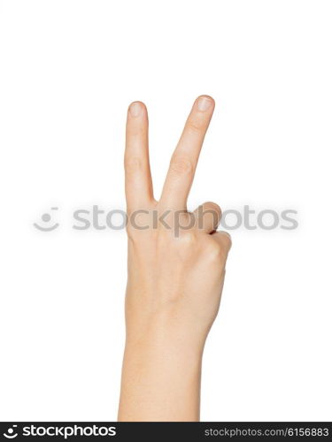 gesture and body parts concept - close up of woman hand showing peace or victory sign. close up of hand showing peace or victory sign