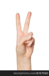 gesture and body parts concept - close up of woman hand showing peace or victory sign. close up of hand showing peace or victory sign