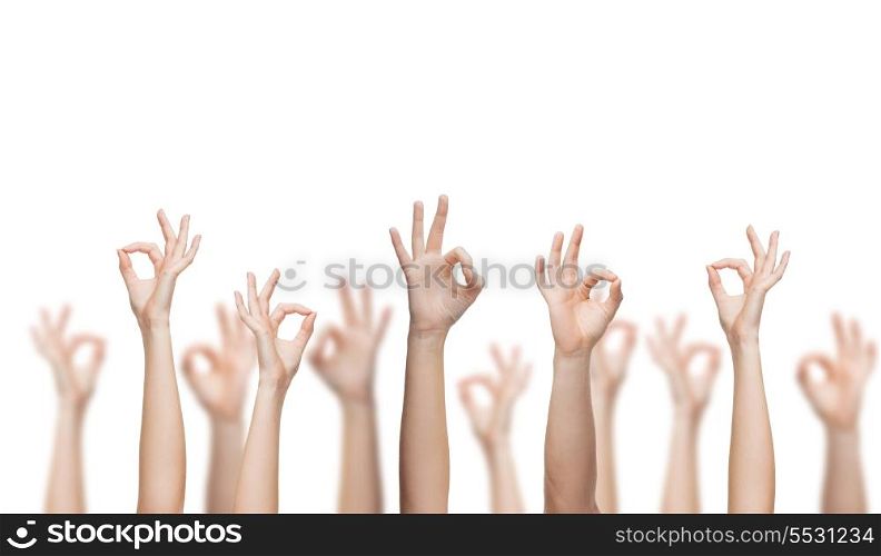 gesture and body parts concept - human hands showing ok sign
