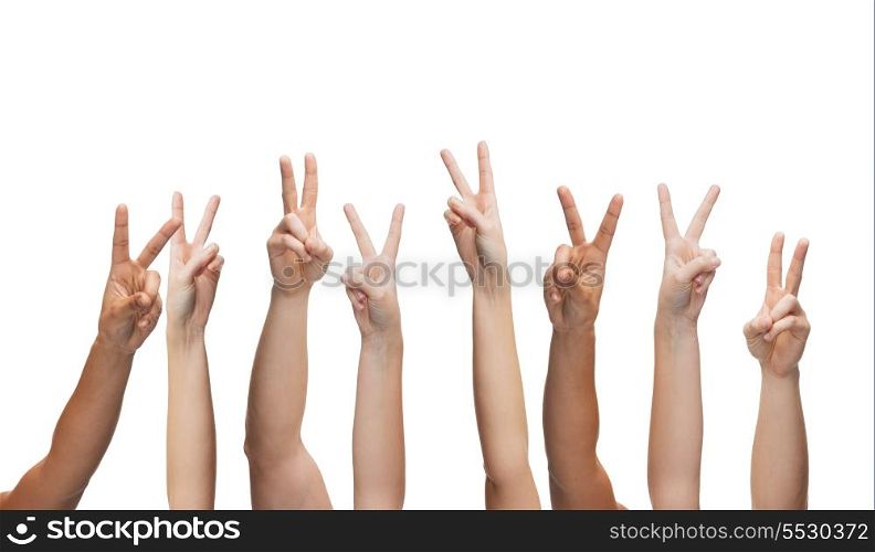 gesture and body parts concept - human hands showing v-sign