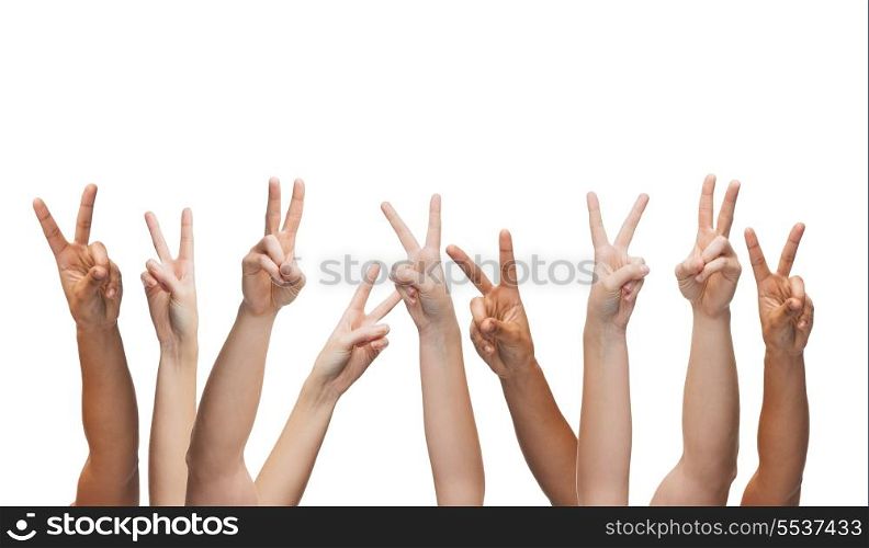 gesture and body parts concept - human hands showing v-sign