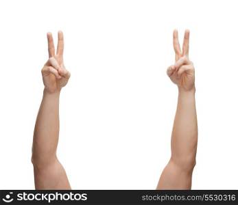 gesture and body parts concept - man hands showing v-sign
