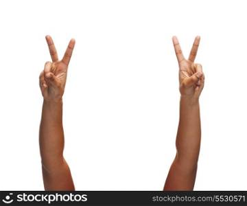 gesture and body parts concept - woman hands showing v-sign