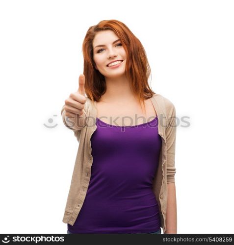 gesture and happy people concept - smiling girl in casual clothes showing thumbs up