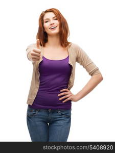 gesture and happy people concept - smiling girl in casual clothes showing thumbs up