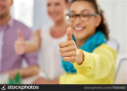 gesture and people concept - close up of happy young woman showing thumbs up. happy young woman showing thumbs up