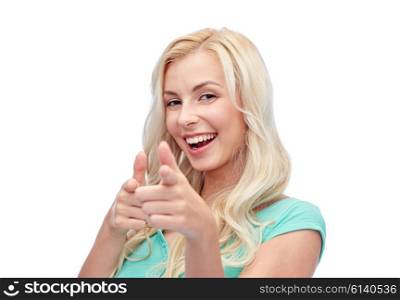gesture and people concept - happy smiling young woman or teenage girl pointing finger to you. happy young woman pointing finger to you