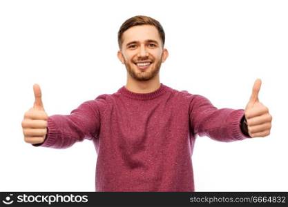 gesture and people concept - happy young man showing thumbs up over white background. happy young man showing thumbs up