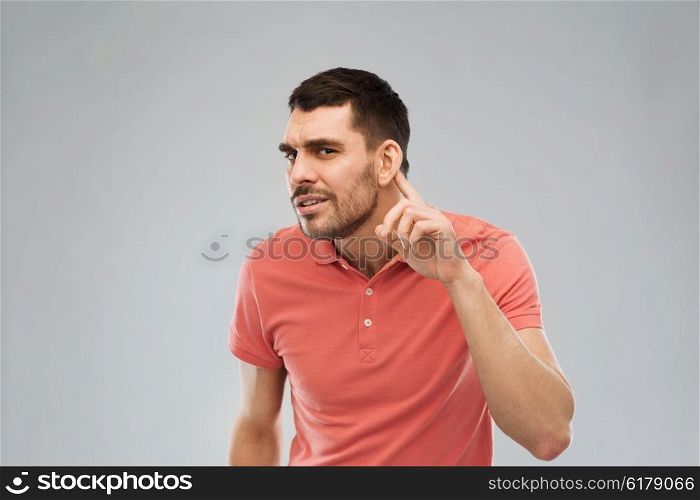 gesture and people concept - latin man having hearing problem listening to something. man having hearing problem listening to something