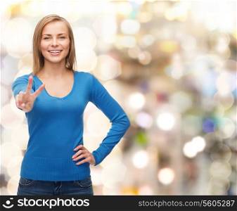 gesture and people concept - smiling teenage girl showing v-sign with hand