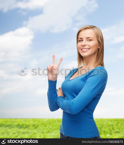 gesture and people concept - smiling teenage girl showing v-sign with hand