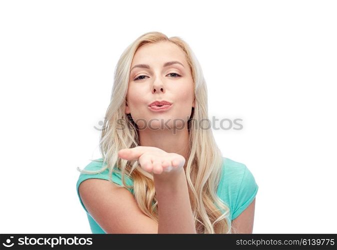 gesture and people concept - smiling young woman or teenage girl sending blow kiss. smiling young woman or teen girl sending blow kiss