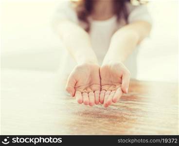 gesture, body parts and child concept - close up of little girl showing empty cupped hands