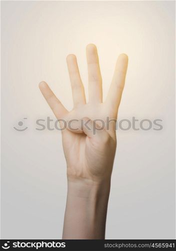 gesture, count and body parts concept - close up of hand showing four fingers