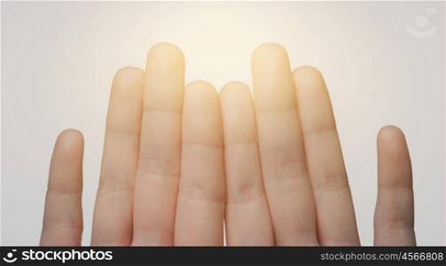 gesture, family, count and body parts concept - close up of hands showing eight fingers