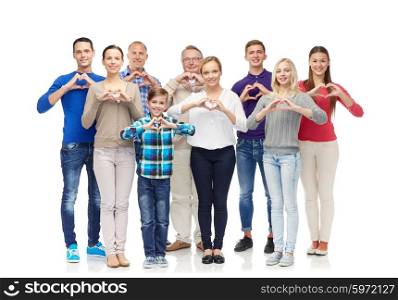 gesture, family, generation and people concept - group of smiling men, women and boy showing heart shape hand sign