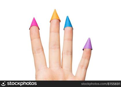 gesture, family, holidays and body parts concept - close up of hand showing four fingers with party hats