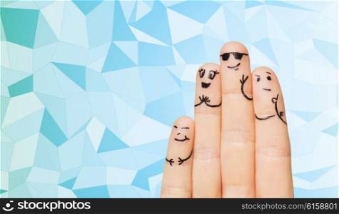 gesture, family, people and body parts concept - close up of four fingers with smiley faces over blue low poly texture background,